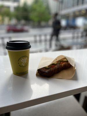 Flat white and a crunchy tomato pesto croissant