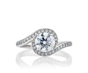 A gorgeous contemporary style engagement ring set in 14k white gold with a .75CT diamond center and .50CT of accent diamonds