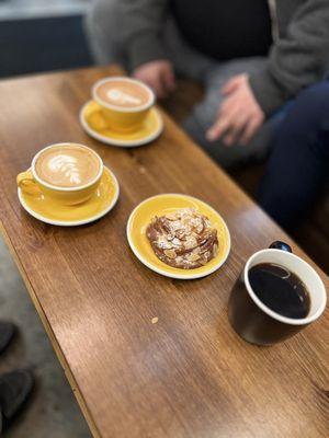 Flat white, mocha, black coffee, and almond bun