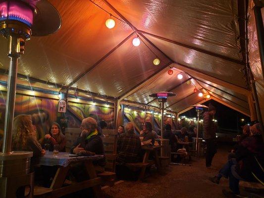 Heated outdoor tent seating.