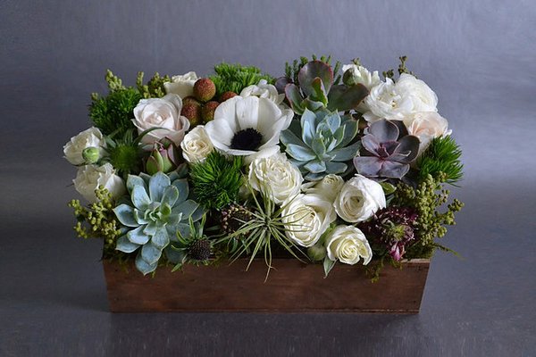 Fresh arrangements and plants in our Signature rustic wood boxes created by a local artisan....no 2 are alike!  www.lovejoyflowershop.com