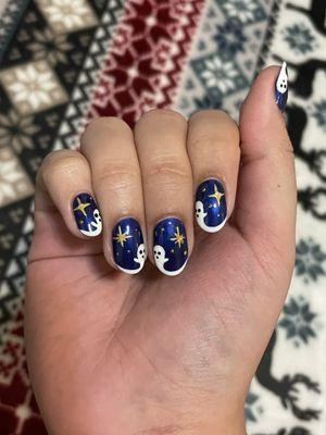 Ghost and Star nails on a dark blue background. Stars are metallic gold and the ghosts extend from the French tip.