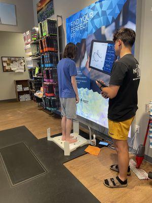 My son getting his feet measured.