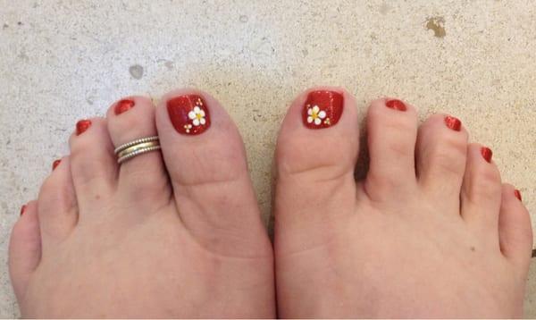 Great design on my toes. Red first coat, red glitter second coat, with a daisy flower.