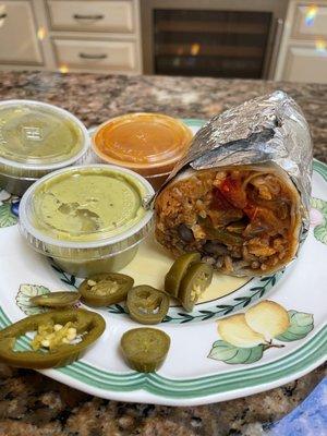 Grilled veggie burrito with jalapeños and salsas on the side