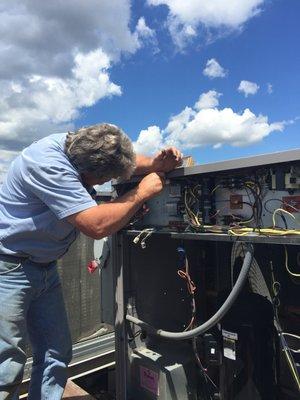 Servicing an industrial HVAC unit.