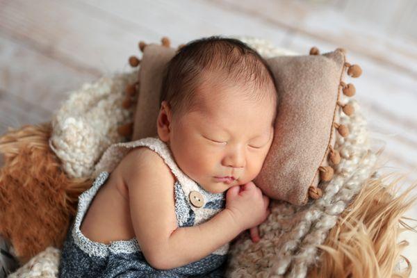 Baby Boy Sleeping in Basket