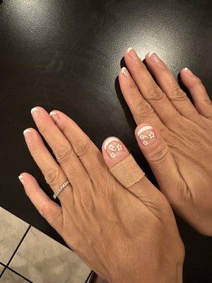 Hand manicure with French tip and flower decal