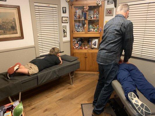 Noah getting an adjustment while his brother Zachery, admiring Dr. Mark's toys, waits for his.