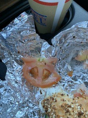 A sliced tomato with a core in it