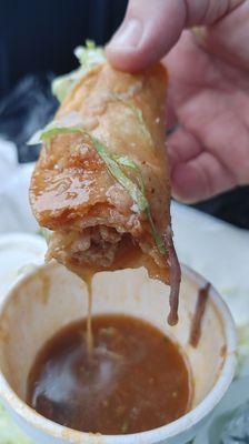 Chicken flautas dipped in birria broth.