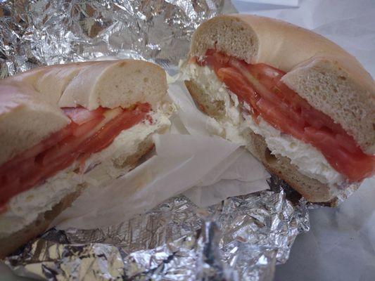 plain bagel with lox, cream cheese onion and tomato.