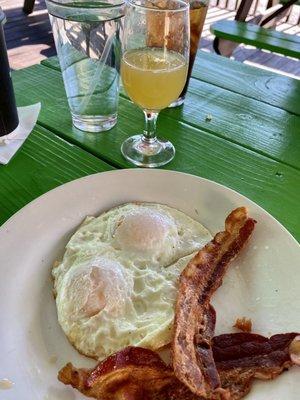 Eggs over easy with bacon and a mimosa!