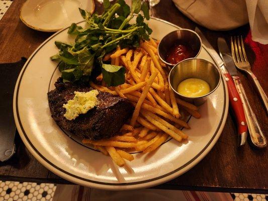 The highlight of the meal-the hanger steak with shoestring fries and greens