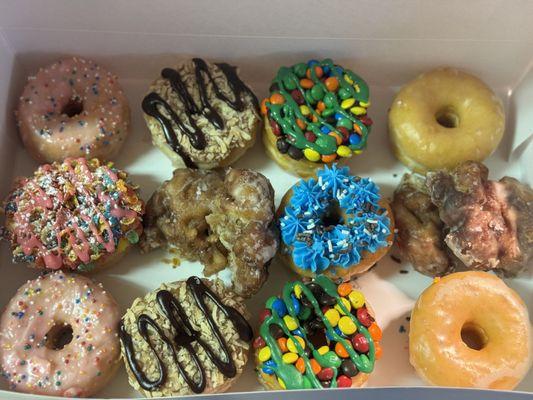 Pink Iced, glazed, apple fritter, M&M, Fruity Pebbles, GS Samosa & blue iced