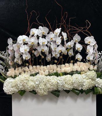 A refined composition of pristine orchids, roses, and hydrangeas