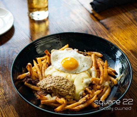 RUST BELT FRITES Short rib, fried egg, brown gravy, white cheddar curd, whole grain mustard