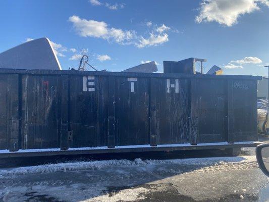 Dumpster taking up parking lot parking spots which we are already short on.