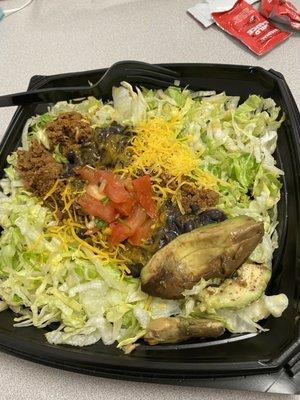 Taco salad with a side of rotten avocado.