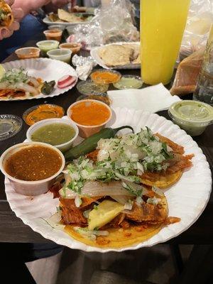 Al pastor tacos with toppings and sauces