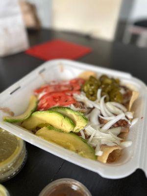 Al pastor nachos.. not your traditional nachos. Not enough cheese or meat. The large avocados, onions and tomatoes are a bit odd.