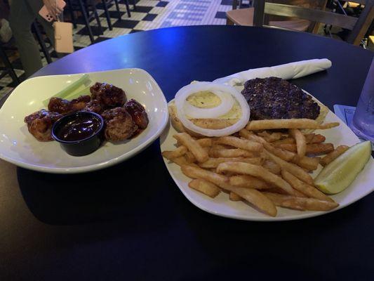 Boneless wings, burger with fries and pickle.