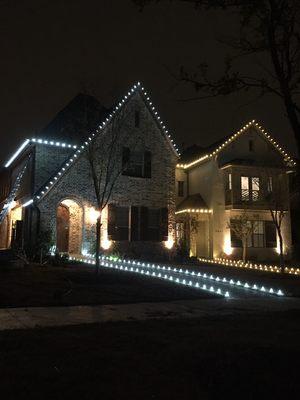 Christmas lights on two neighboring homes in Las Colinas, Irving, Texas