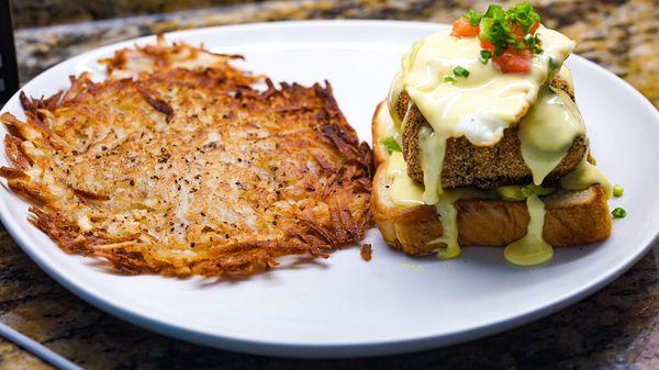 Deep fried salmon egg Benedict with a garlic hollandaise sauce and hash browns