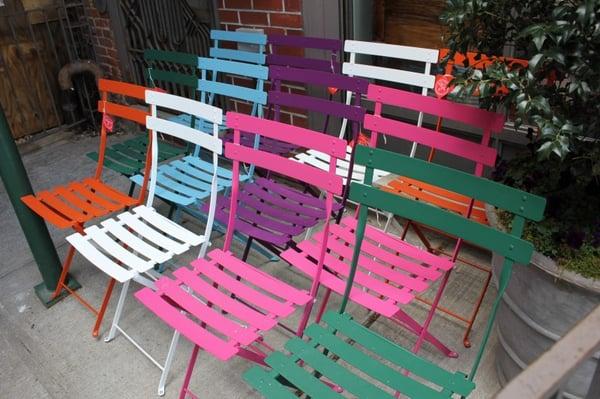 Display of chairs our front.  I'll take one in every color please.