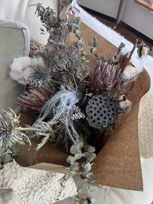 Dried floral arrangement from Emilia's with lotus, proteas, and cottonwood