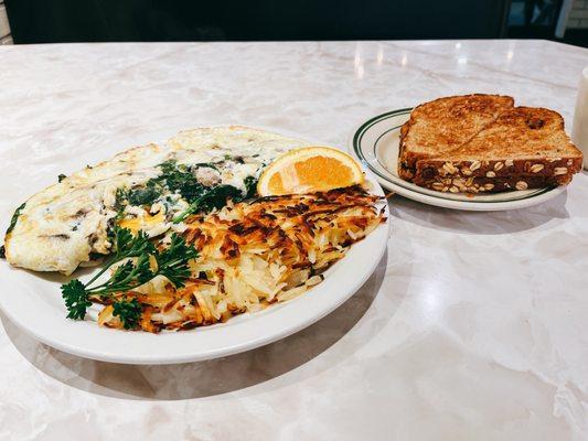 Spinach, mushroom, avocado , cheese egg white omelet with has browns and wheat toast