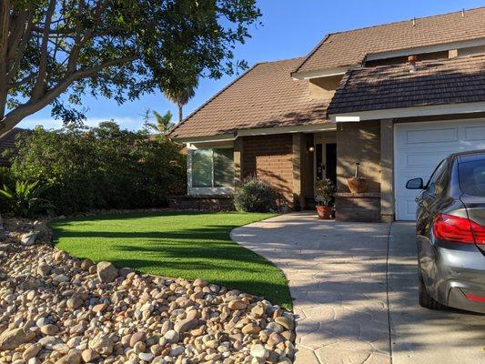 Our stamped concrete front walk, new artificial sod, and rock landscaping. Exactly what we requested.