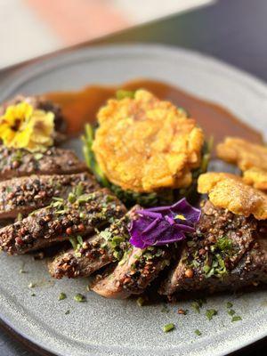 See ribeye with veal, demiglaze, and sautéed spinach fried Tostones