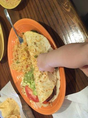 Enormous, delicious veggie quesadilla. Baby hand for scale