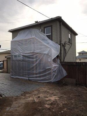 Protecting the new framing from the rains that are possibly coming next week.