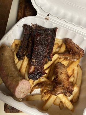 Combo plate: ribs, sausage and chicken wings. Comes w two sides. I got fries and slaw (not pictured)