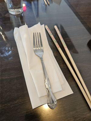 Utensils and chop sticks, napkins delivered in a white paper bag