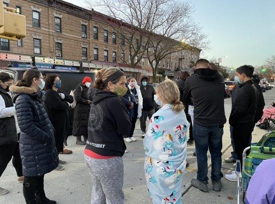 Crowd gathers as numbers are distributed