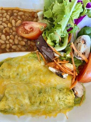 Two enchilada entree with spicy cajun white beans and a salad.