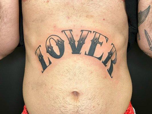 "Lover" tattoo in American Traditional script