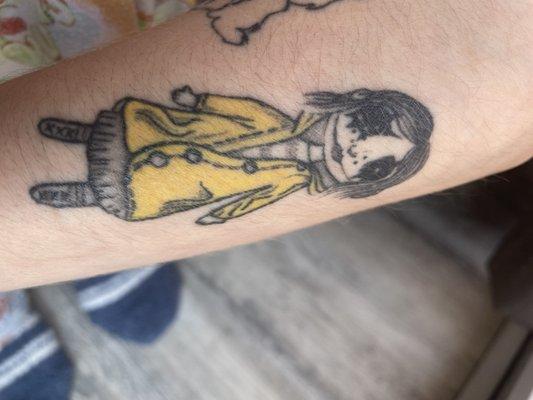 This coraline doll tattoo lupita did, and she added a touch of her style to the buttons eyes.