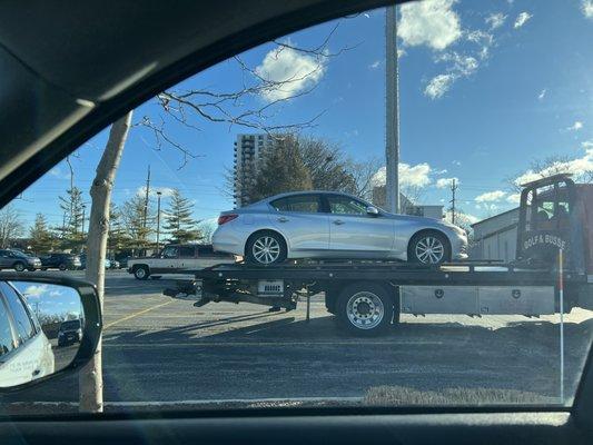 Here's my car on their tow truck - no dent in the fender.