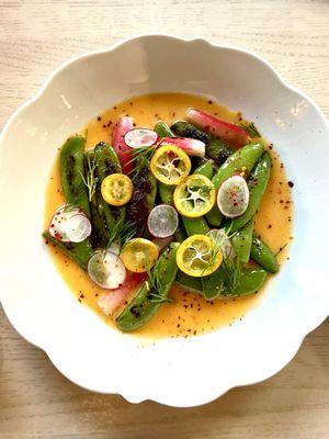 Charred pea pods and radishes