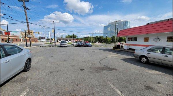 The parking lot at the side of the building.