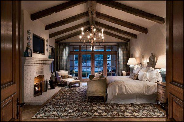 Beautiful bedroom with a fireplace of its own.