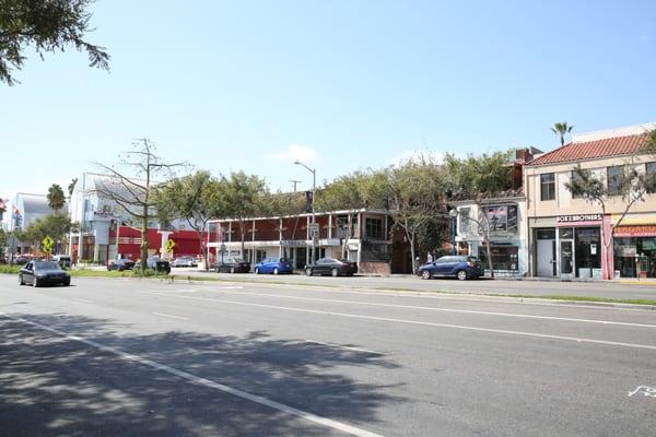 Visual of location parking is between the Ramada and are two story building