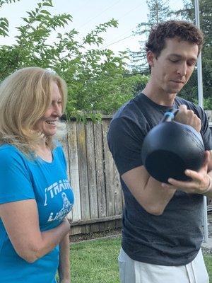 Showing one my awesome clients how to properly rack a kettlebell.