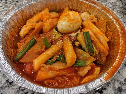 Dduk-Bok-Kee. Sauteed rice cakes, fish cakes, cabbages, onions, carrots, hard boiled egg in a spicy red pepper sauce. $10.99.