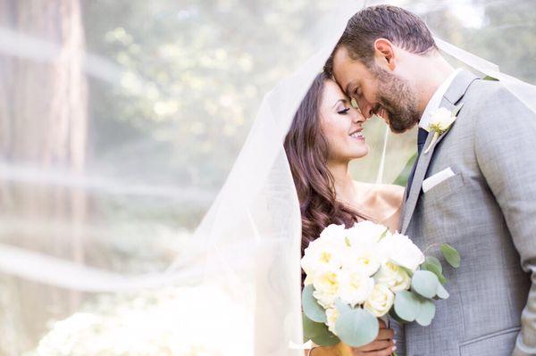 An amazing intimate shot of our bride and groom with the veil in the amazing venue Nestledown!