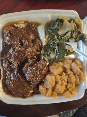 Jurk oxtails with rice, cabbage and collard greens mixed, and rutabaga.